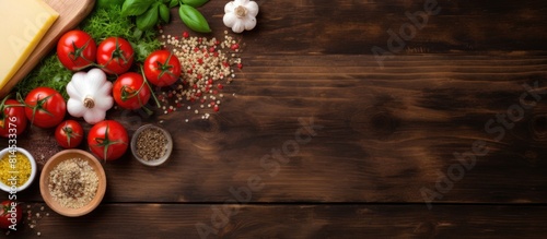 Top view copy space image of pizza ingredients and recipe notebook on wooden table creating a still life scene