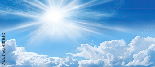 Sunny blue skies peek through wispy clouds in a captivating image offering ample copy space for a versatile and abstract background