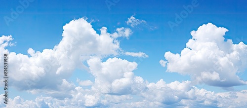 Blue sky with white clouds as a copy space image for a background