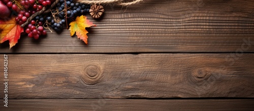 Top view of a stunning autumn composition featuring dry leaves berries and a rope on a wooden background Perfect copy space image
