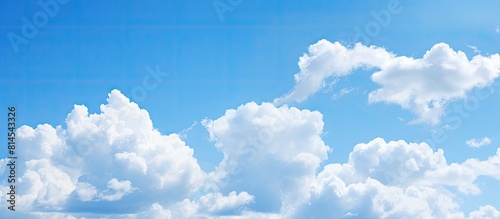 Copy space image of a serene blue sky adorned with delicate clouds