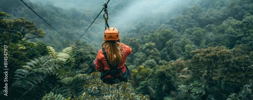 Female tourist taking zip line tour though Monteverde Cloud Forest, Costa Rica