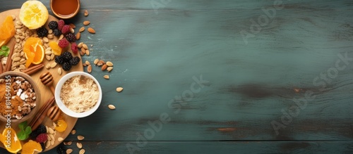 Fototapeta Naklejka Na Ścianę i Meble -  A healthy breakfast set consisting of granola with dry fruits nuts and honey presented from a top view with ample copy space in the image
