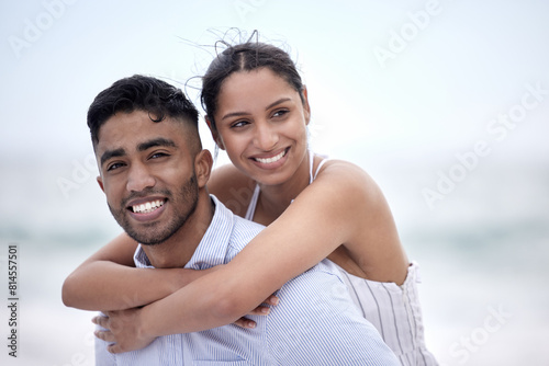 Beach, piggyback and couple with love for travel, summer vacation or adventure. Smile, ocean and happy woman hugging man on afternoon date for honeymoon, anniversary or weekend trip in Maldives © peopleimages.com