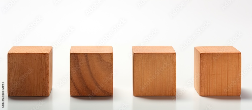 Four identical wooden cubes are arranged on a white background positioned both in a row and individually with some cubes placed directly and others at an angle There is ample space for text to be add