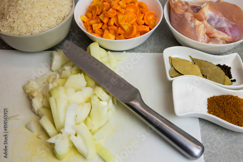 The chef prepares homemade crispy fried chicken with carrots and onions, spices.