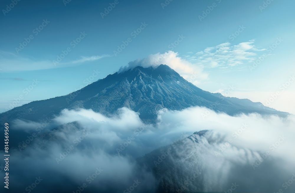 Fototapeta premium Mountain Blanketed in Clouds and Trees