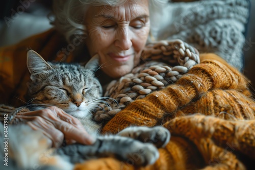 A senior woman knitting with her sleeping cat and dog beside her, portraying peaceful coexistence and multipet households photo