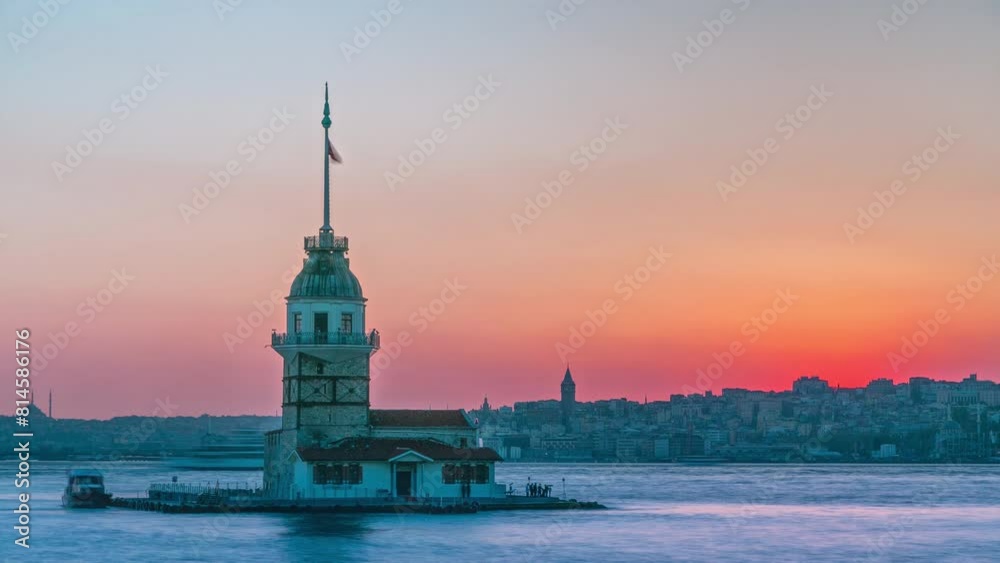 Maidens tower with beautiful orange sunset timelapse in Istanbul, turkey, kiz kulesi tower. City skyline on background with reflection on Bosforus water Maidens tower with beautiful orange sunset timelapse in Istanbul, turkey, kiz kulesi tower. City skyline on background with reflection on Bosforus water
