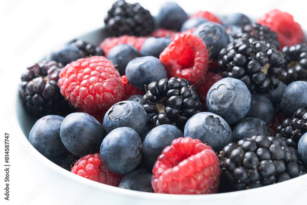 Fresh assortment berries isolated on white background. Close up Fresh assortment berries isolated on white background. Close up