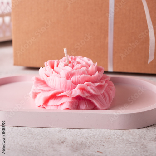 Interior candle in the form of a peony on a tray photo