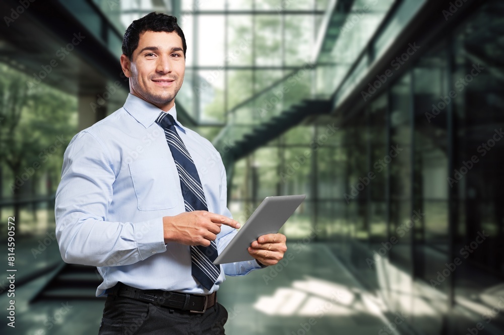 Fototapeta premium Smiling busy business manager hold tablet computer