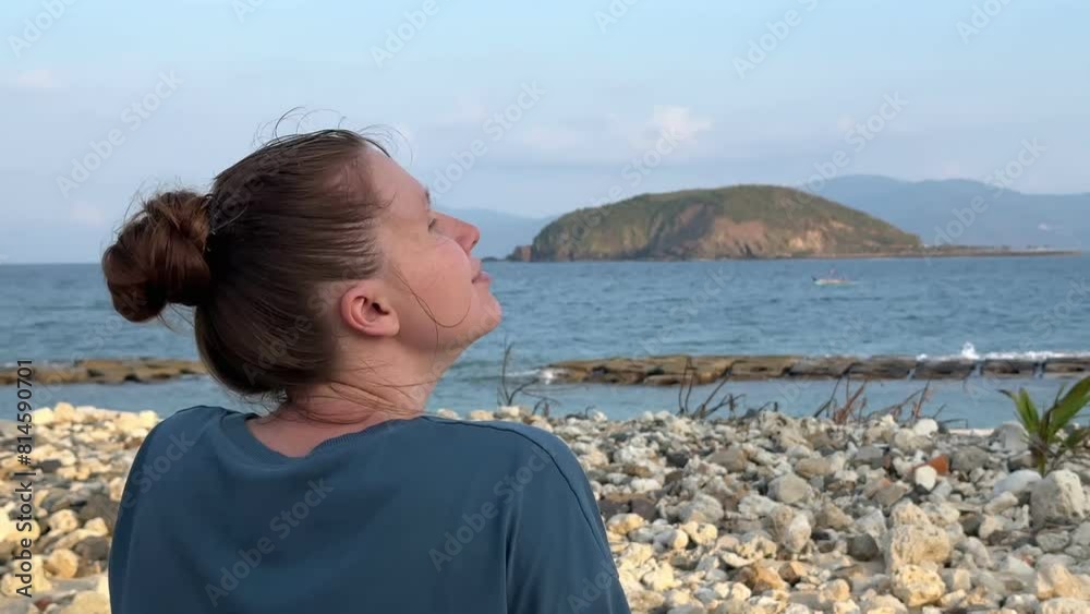 Young woman enjoying sea view on the beach on sunset Young woman enjoying sea view on the beach on sunset