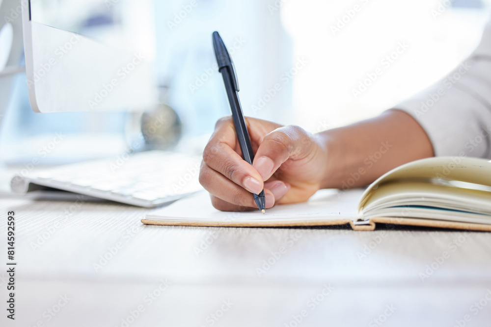 Pen, notebook and writing at desk for research, closeup and hand for planning in office. Computer, schedule or reminder with notes for business person, journalist and planner or brainstorm in journal Pen, notebook and writing at desk for research, closeup and hand for planning in office. Computer, schedule or reminder with notes for business person, journalist and planner or brainstorm in journal