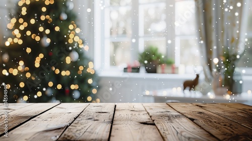 Empty woooden table top with abstract warm living room decor with christmas tree string light blur background with snow,Holiday backdrop,Mock up banner for display of advertise product  photo