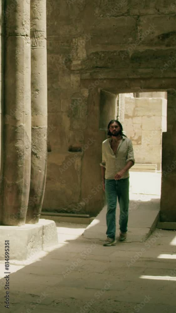 Traveler in an Egyptian temple's hall slow motions vertical video. Traveler in an Egyptian temple's hall slow motions vertical video.