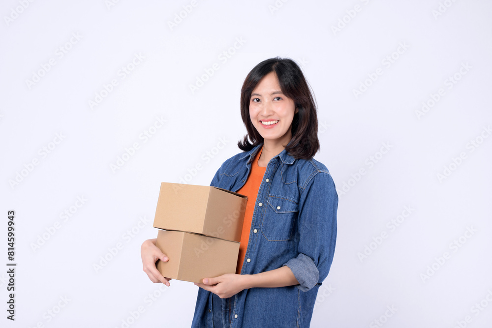 young asian woman wearing orange t-shirt and denim shirt holding parcel box isolated on white studio background, Delivery courier and shipping service concept. young asian woman wearing orange t-shirt and denim shirt holding parcel box isolated on white studio background, Delivery courier and shipping service concept.