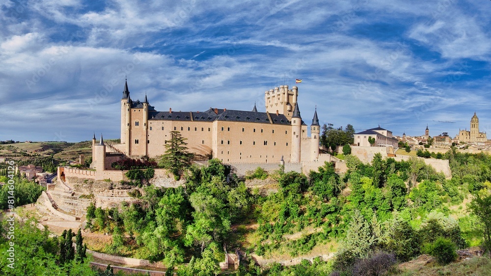 Majestic Segovia Castle surrounded by lush green trees. Spain Majestic Segovia Castle surrounded by lush green trees. Spain