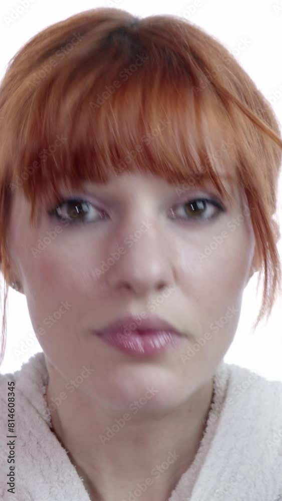 Red hair beautiful woman looking at herself in the bathroom mirror at home Red hair beautiful woman looking at herself in the bathroom mirror at home