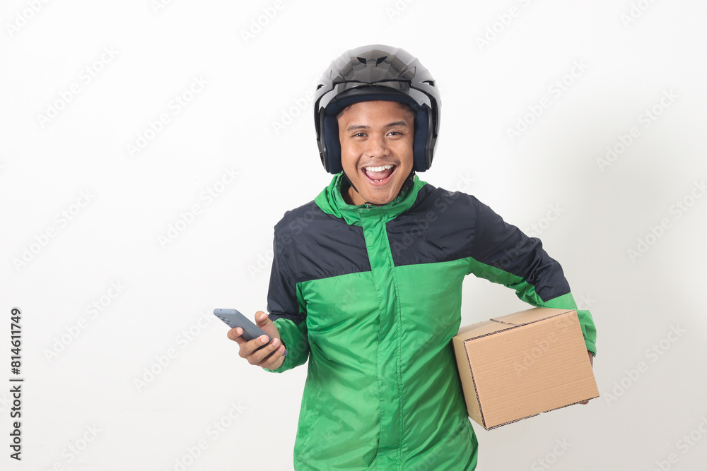 Portrait of Asian online courier driver wearing green jacket and helmet delivering package and box for customer while using mobile phone and taking order. Isolated image on white background Portrait of Asian online courier driver wearing green jacket and helmet delivering package and box for customer while using mobile phone and taking order. Isolated image on white background
