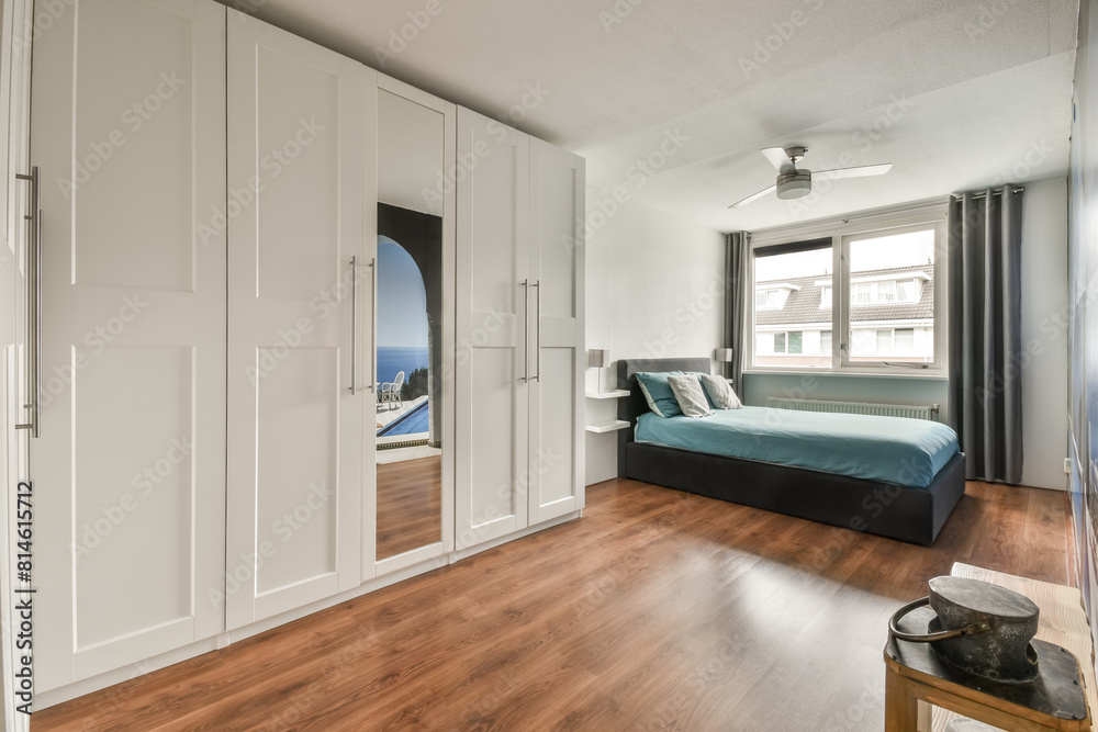 Modern bedroom interior with large window and sea view