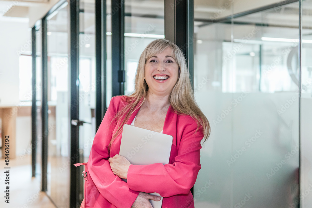 Confident businesswoman with laptop in modern coworking space Confident businesswoman with laptop in modern coworking space