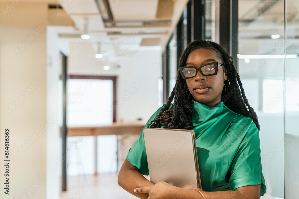Professional woman with laptop in modern coworking space Professional woman with laptop in modern coworking space