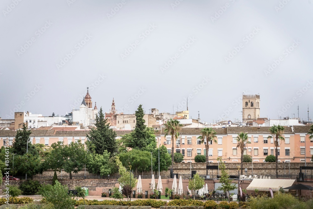 Photograph of the capital of Badajoz with the buildings and the church in the background on a cloudy Photograph of the capital of Badajoz with the buildings and the church in the background on a cloudy