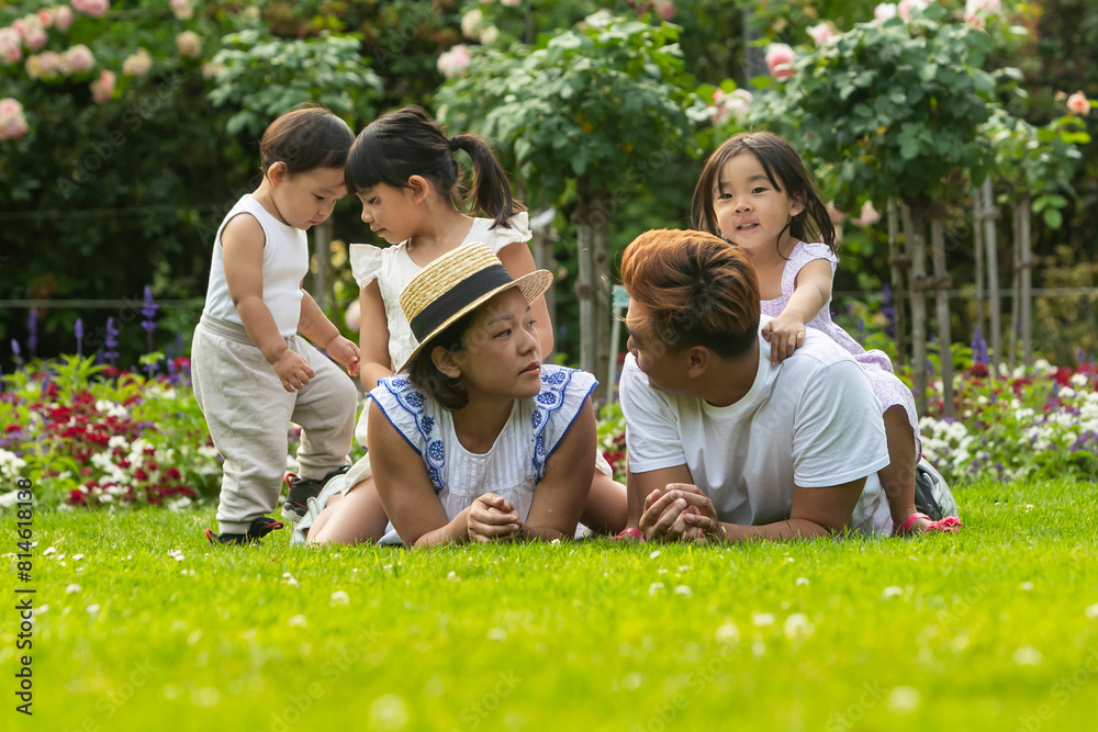 Asian family enjoying a vacation in a European garden Asian family enjoying a vacation in a European garden