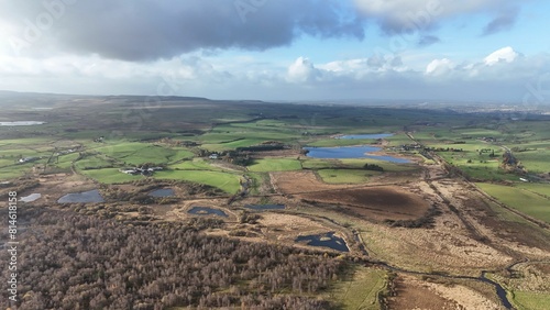 Aerial view of a rural countryside under a bright sky in New Cumnock, Scotland photo