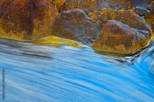 Warm Rocks Against Flowing Water in Rio Tinto