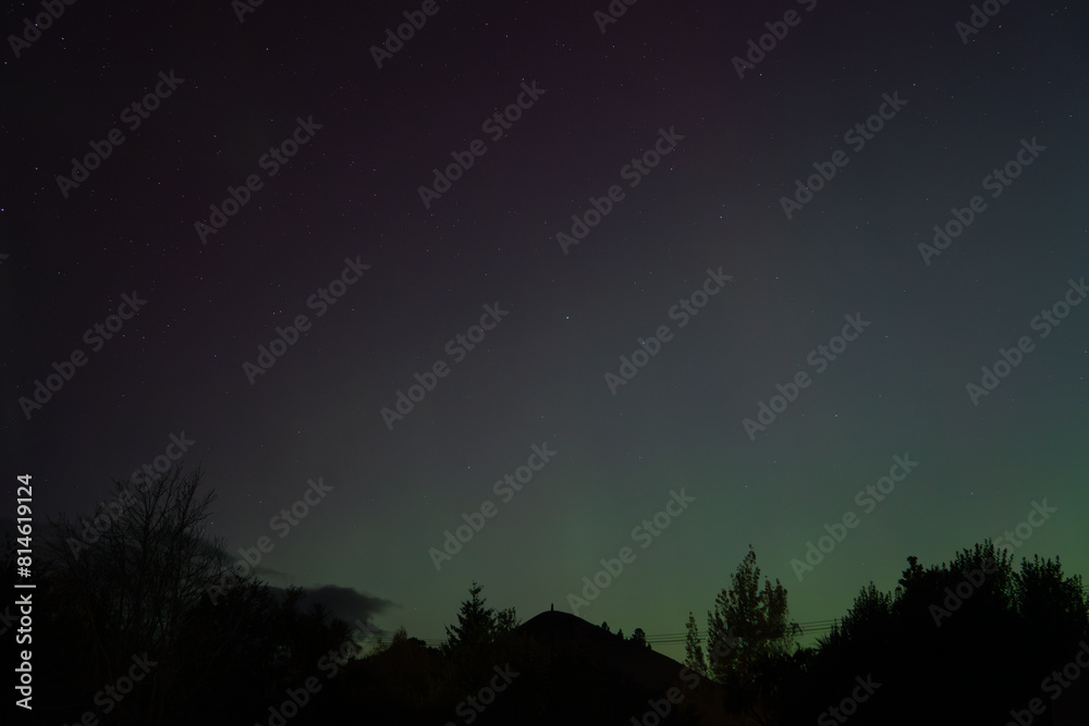 Green and purple colours of Aurora Australis over Puketapu mountain and trees in silhouette. Taken in Palmerston, Otago (New Zealand) where the southern lights can sometimes be seen, in May 2024. Green and purple colours of Aurora Australis over Puketapu mountain and trees in silhouette. Taken in Palmerston, Otago (New Zealand) where the southern lights can sometimes be seen, in May 2024.