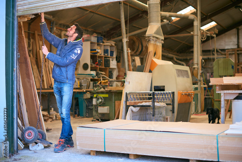 Carpenter Opening Door To Woodwork Business Premises At Start Of Working Day