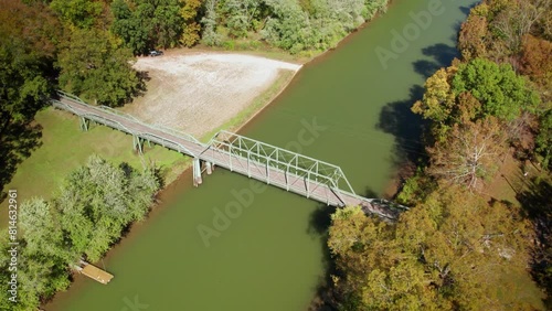 Drone footage of a truss Bridge spans the little Blue River on a sunny day in Alton, Indiana, USA photo