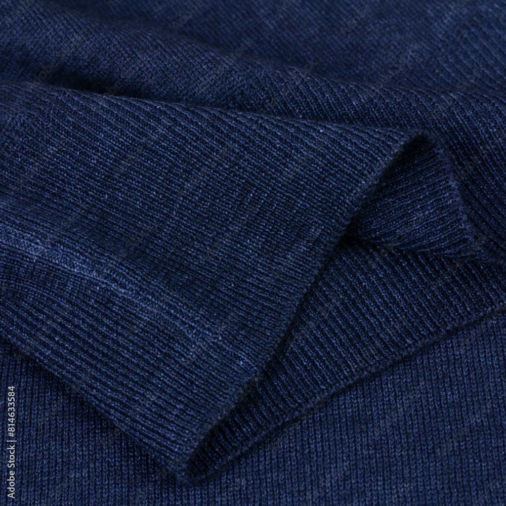 Knitted elastic band on navy blue wool jumper close up Knitted elastic band on navy blue wool jumper close up