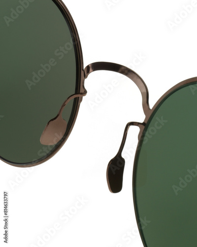 Detail of nose pad and bridge of round Panto shaped metal sunglasses with bronze frames and green lenses