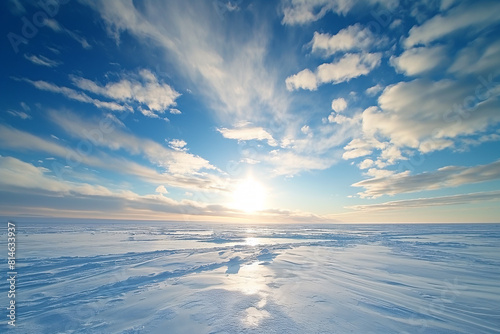 Breathtaking arctic landscape under a sunrise, with sunbeams over the vast ice field and a serene blue sky photo