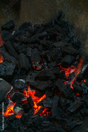 Coals with sparks in a huge old metal grill