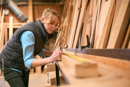 Wallpaper Mural Female Carpenter Working In Woodwork Workshop Measuring Wood For Project Torontodigital.ca