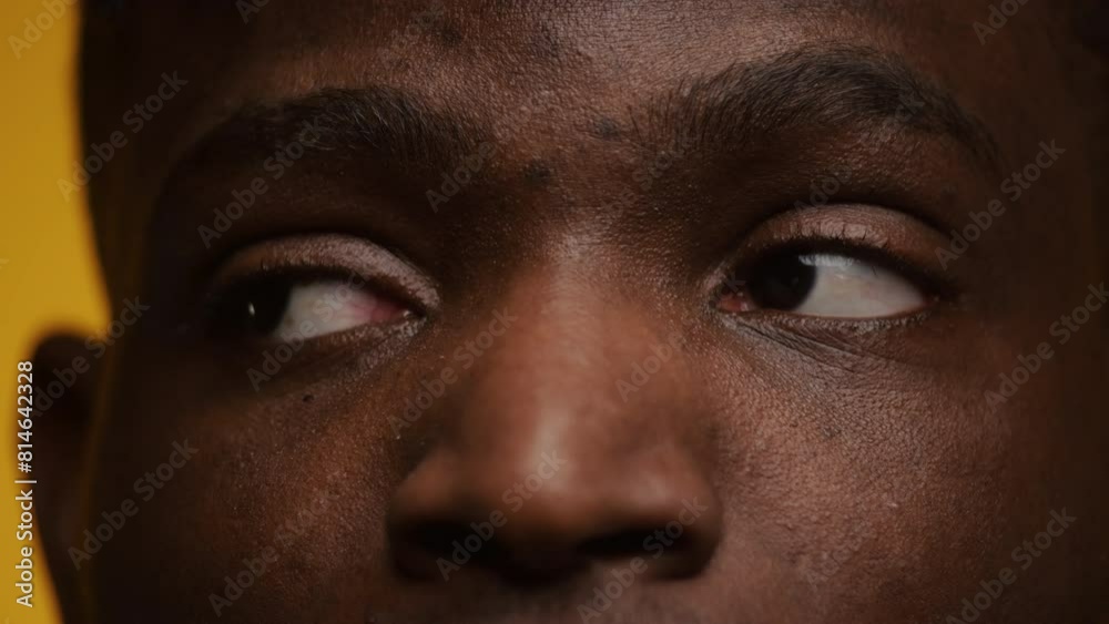 Young Man Eyes Looking Sideways on Yellow Young Man Eyes Looking Sideways on Yellow