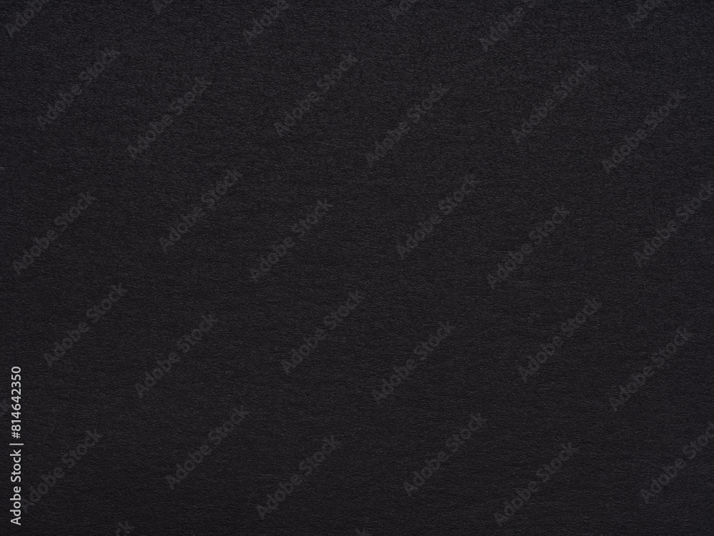 A vast expanse of textured black paper stretches out, evoking depth and a quiet, complex simplicity A vast expanse of textured black paper stretches out, evoking depth and a quiet, complex simplicity