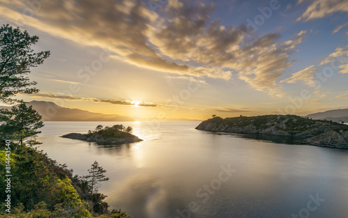 Obraz na płótnie A spectacular sunset in Norway over the bay, islands and fjords
w salonie