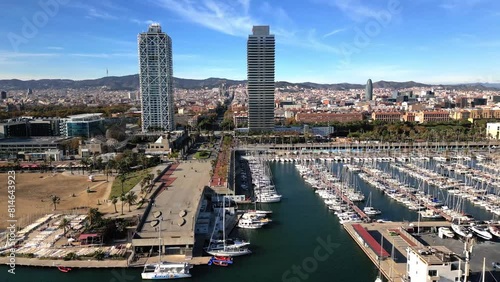 Drone footage of Port Olimpic, Somorrostro beach and urban buildings on seafront of Barcelona, Spain photo