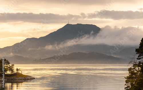 Obraz na płótnie A spectacular sunset among the mountains in the fog over the Norwegian fjords Stord w salonie