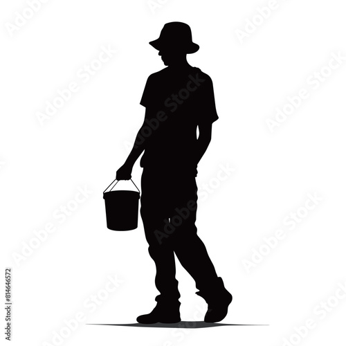 Silhouette of Man with Bucket Walking