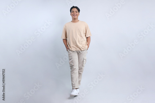 Full Length Of Happy Asian Man Standing Confidently Isolated On White Background