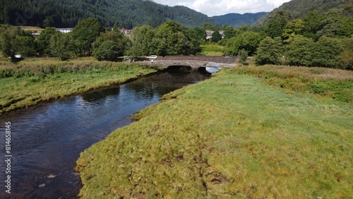 an aerial shot of the river in the woods in scotland photo