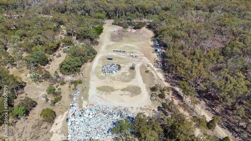 High drone footage of a junkyard in the woods on a sunny day in Emmaville, NSW, Australia photo