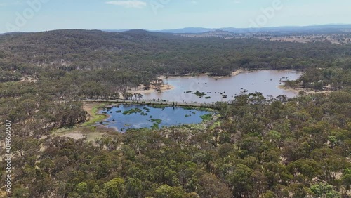 Aerial footage of the Emmaville Road crossing a lake in the woods in Emmaville town, NSW, Australia photo