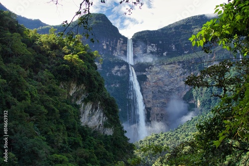 majestic Gocta Falls cascading down from a rocky mountain peak, surrounded by lush greenery photo